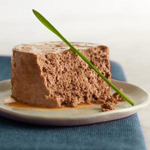 Pate wet cat food plated with garden greens